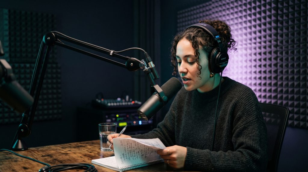 Image of a woman recording a podcast using Layer Eight Marketing Podcasting Services